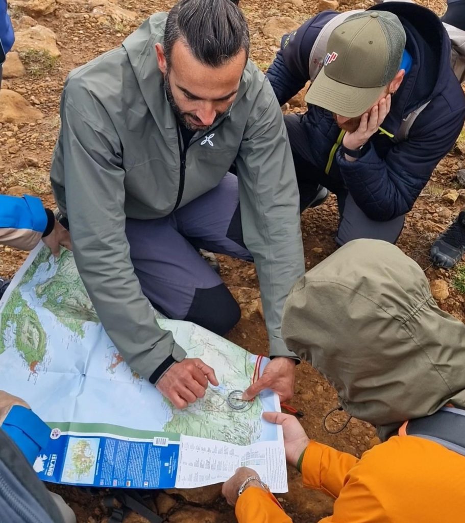 Hikers practicing orienteering with their guide - Day treks