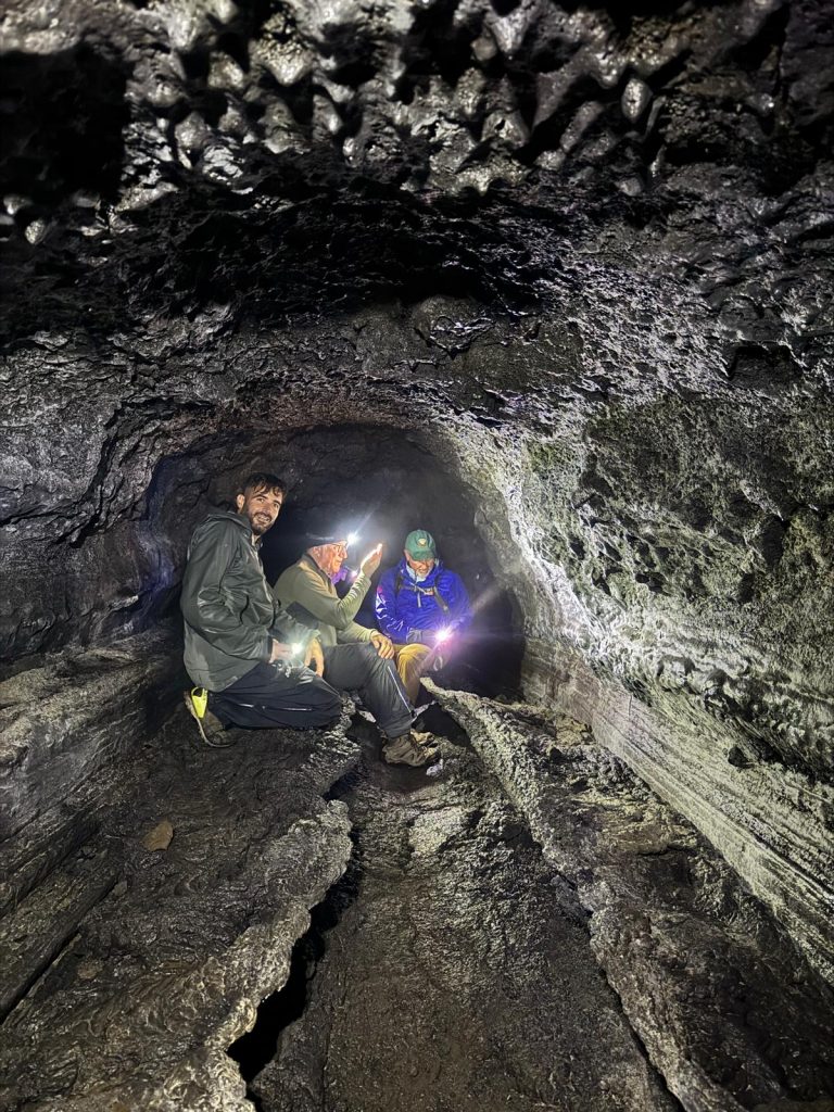Small group in a lava cave in Iceland near Reykjavik