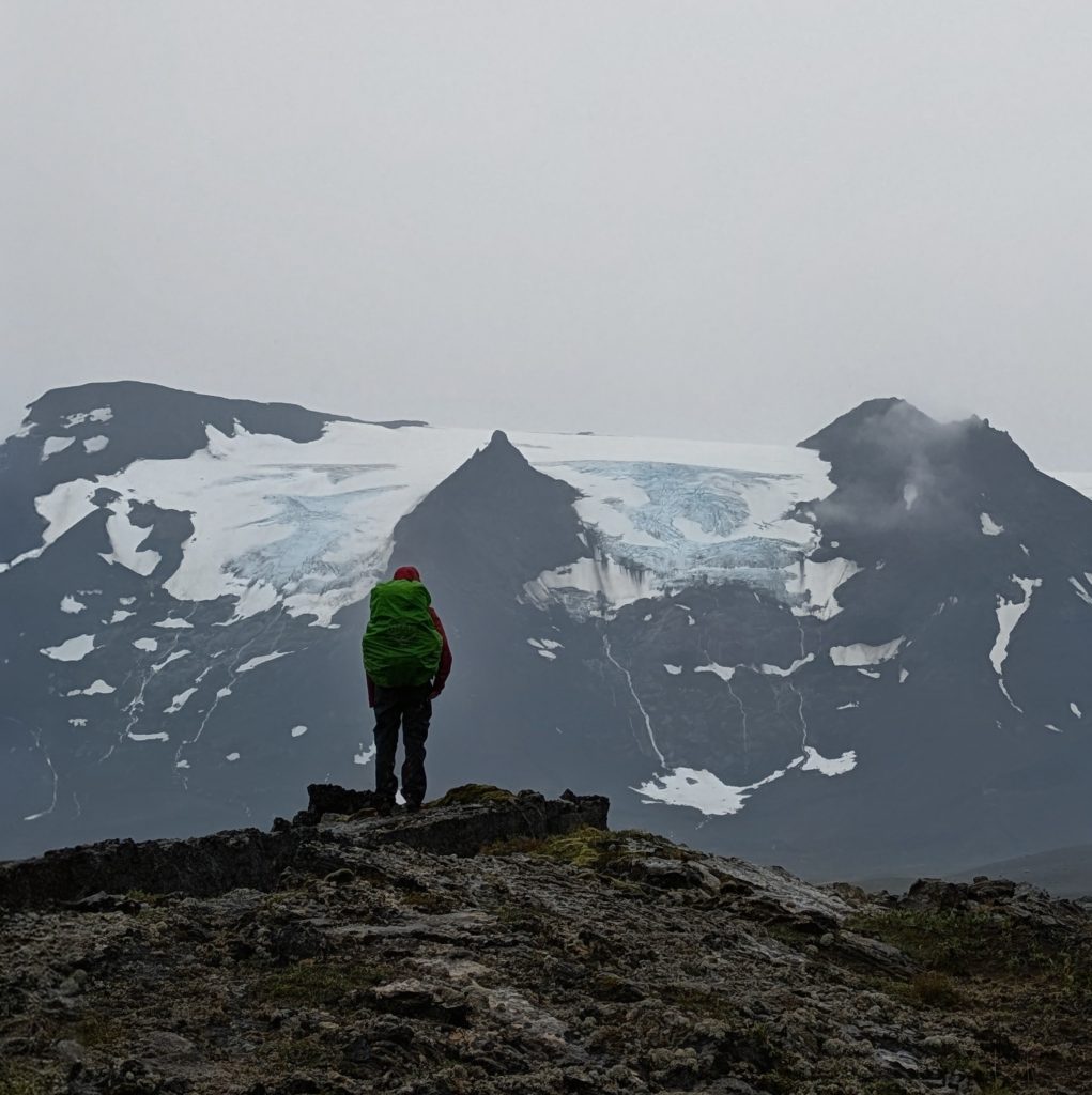 Hiker in front of a stunning glacier - Private Tours in Iceland